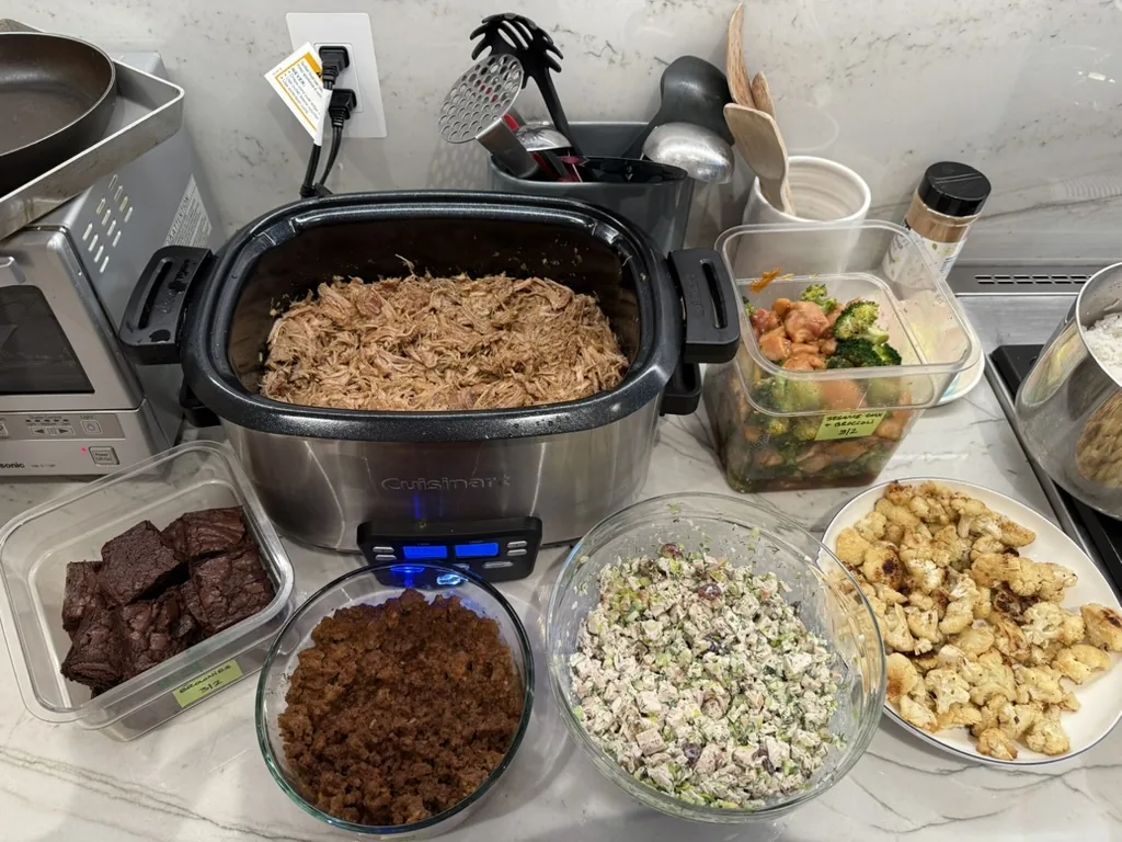 Batch-cooked pulled meat, roasted cauliflower, salad, vegetables, and brownies