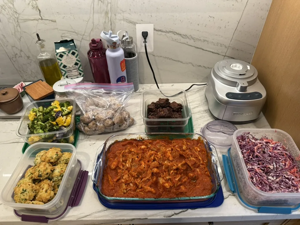 Prepared chicken, vegetables, slaw, biscuits, and brownies ready for the week