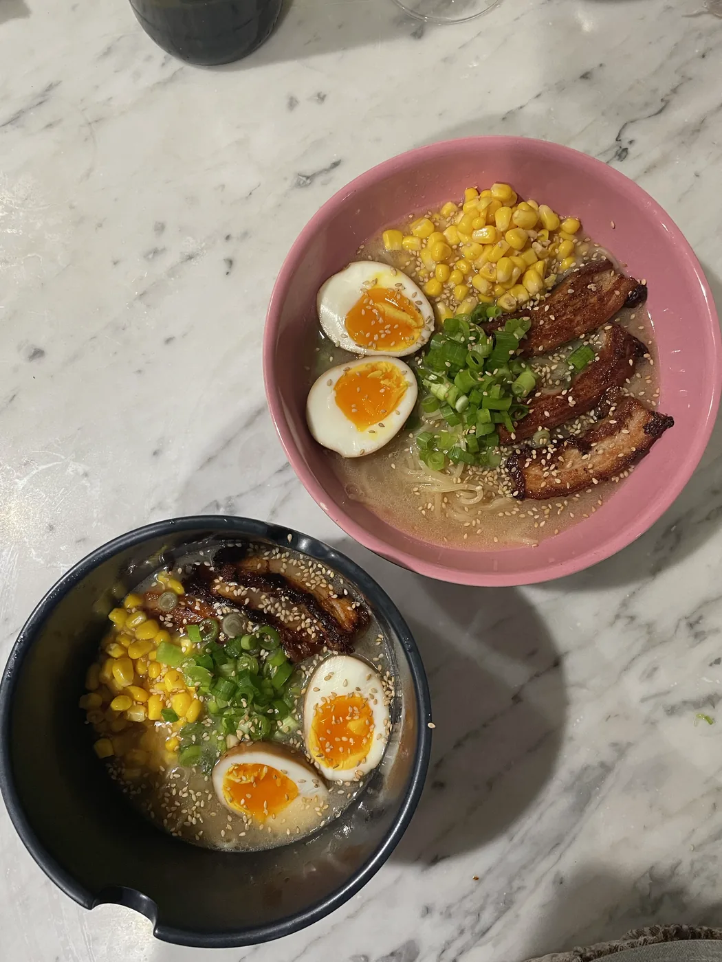 Pork belly ramen with soft-boiled eggs, corn, scallions, and sesame