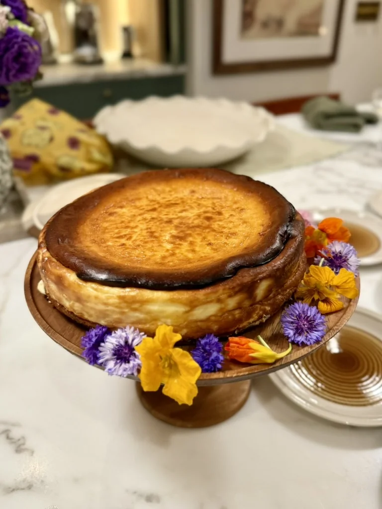 Basque-style cheesecake decorated with edible flowers