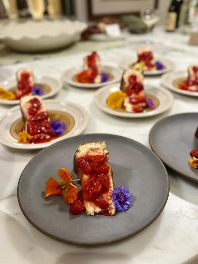 Plated first course finished with tomato and edible flowers