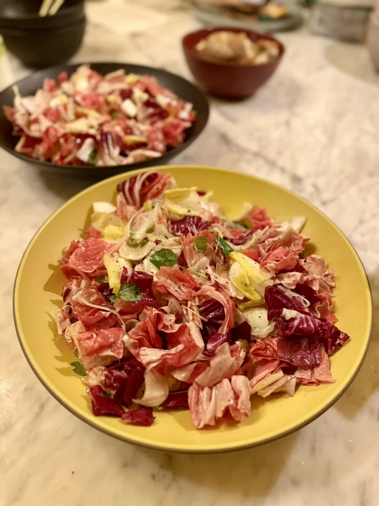 Winter chicory salad in a yellow serving bowl