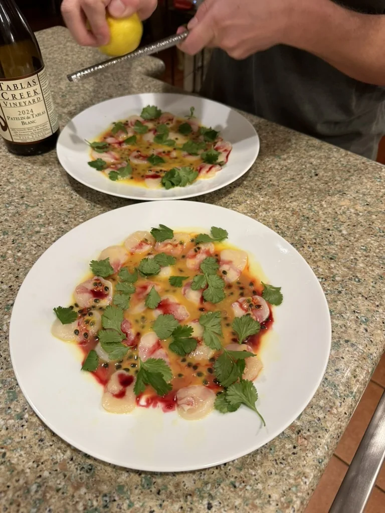 Colorful crudo being finished at the table